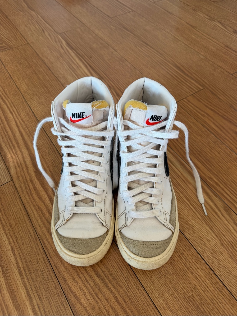 Nike White High-Top Sneakers with Black Swoosh